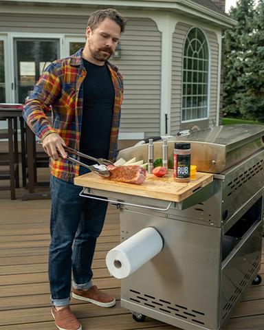 a man preparing to throw a piece of meat on the grill