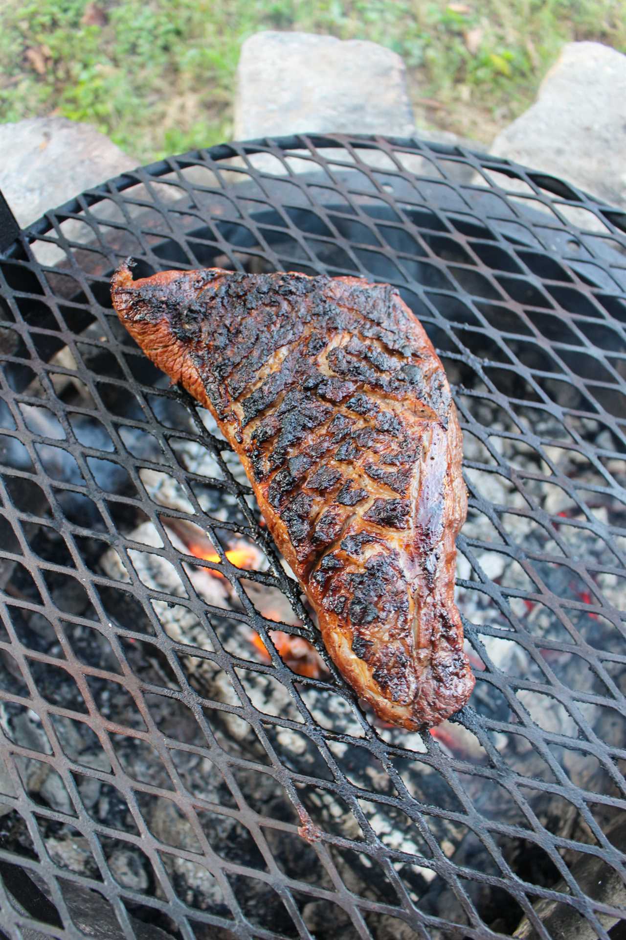 Grilled Steak with Peanut Butter Sauce after the first flip.