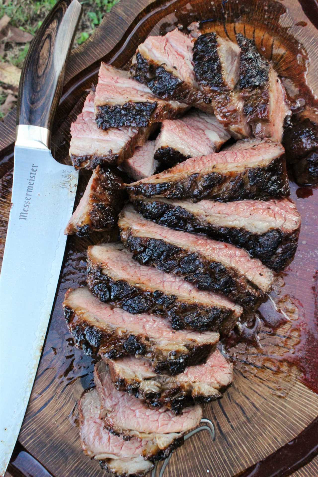 Grilled Steak with Peanut Butter Sauce getting sliced after resting.