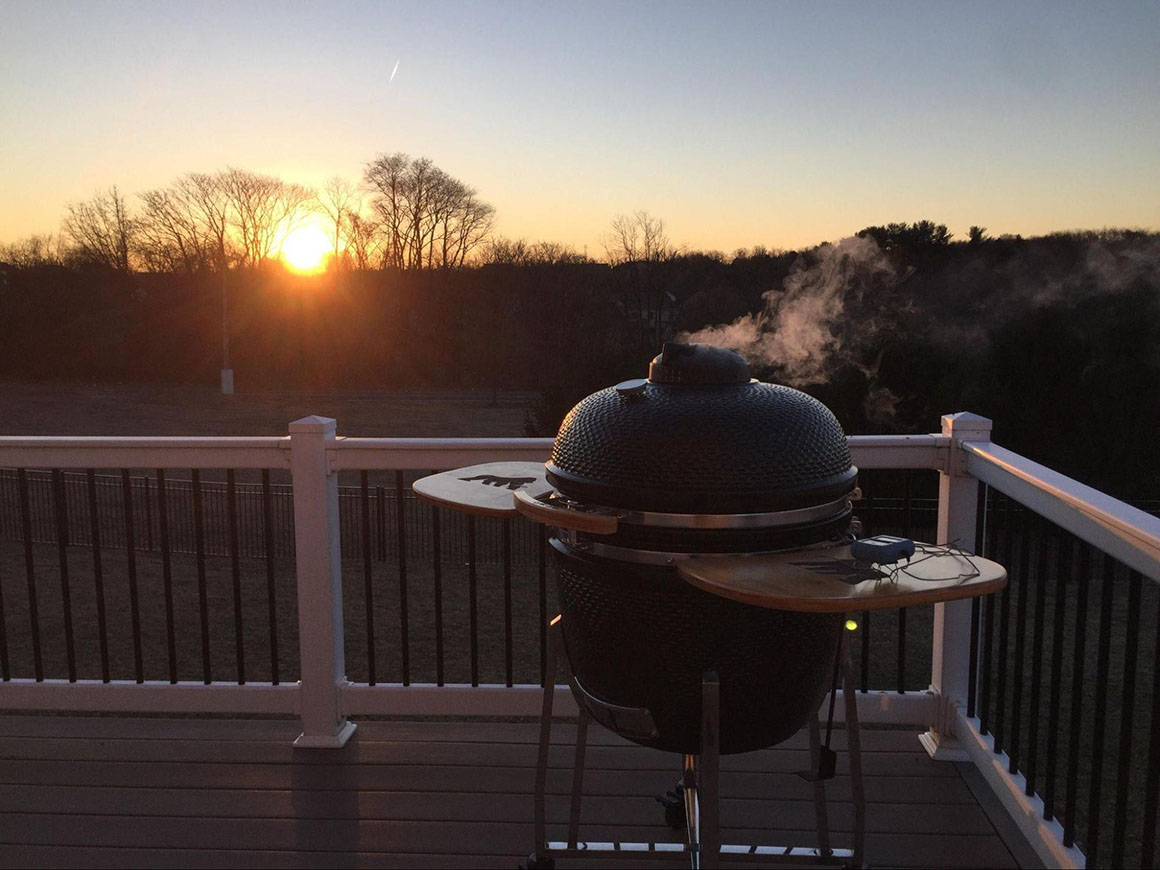 grill smoking on home deck