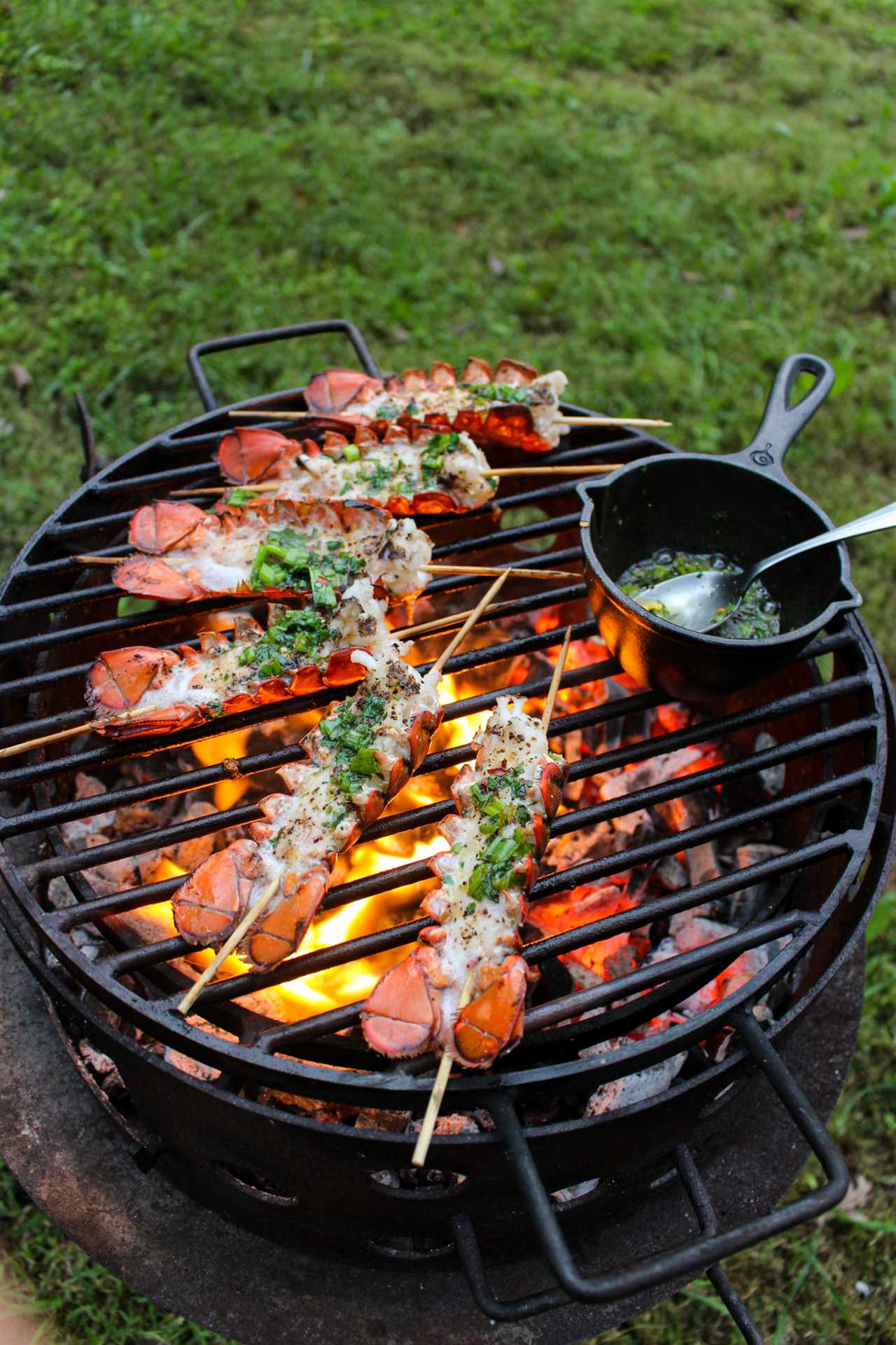 Lobster Skewers with Bang Bang Sauce being basted with herb ghee.