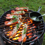 Lobster Skewers with Bang Bang Sauce being basted with herb ghee.