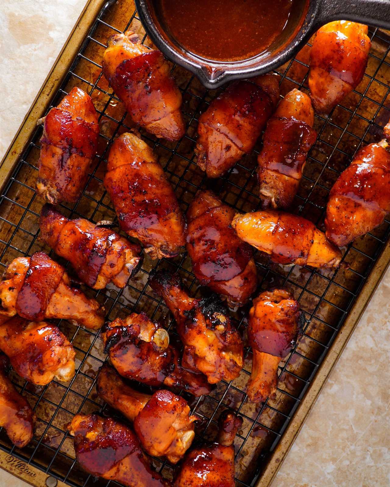 Bourbon Bacon Chicken Wings covered in BBQ sauce.