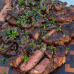 New York Strips with Bourbon Mushrooms sliced and ready to serve.