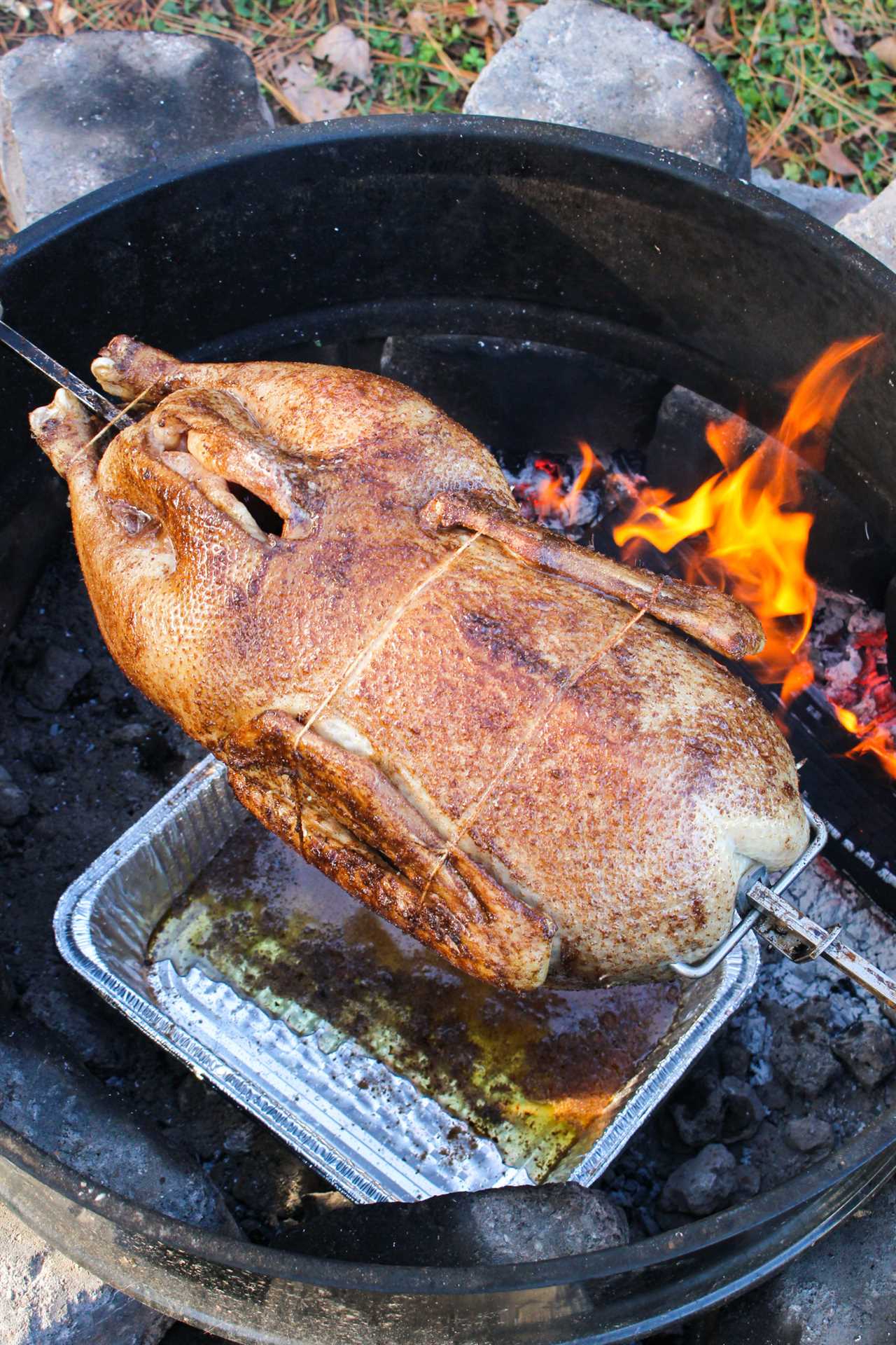 Holiday Rotisserie Goose getting placed on the rotisserie.