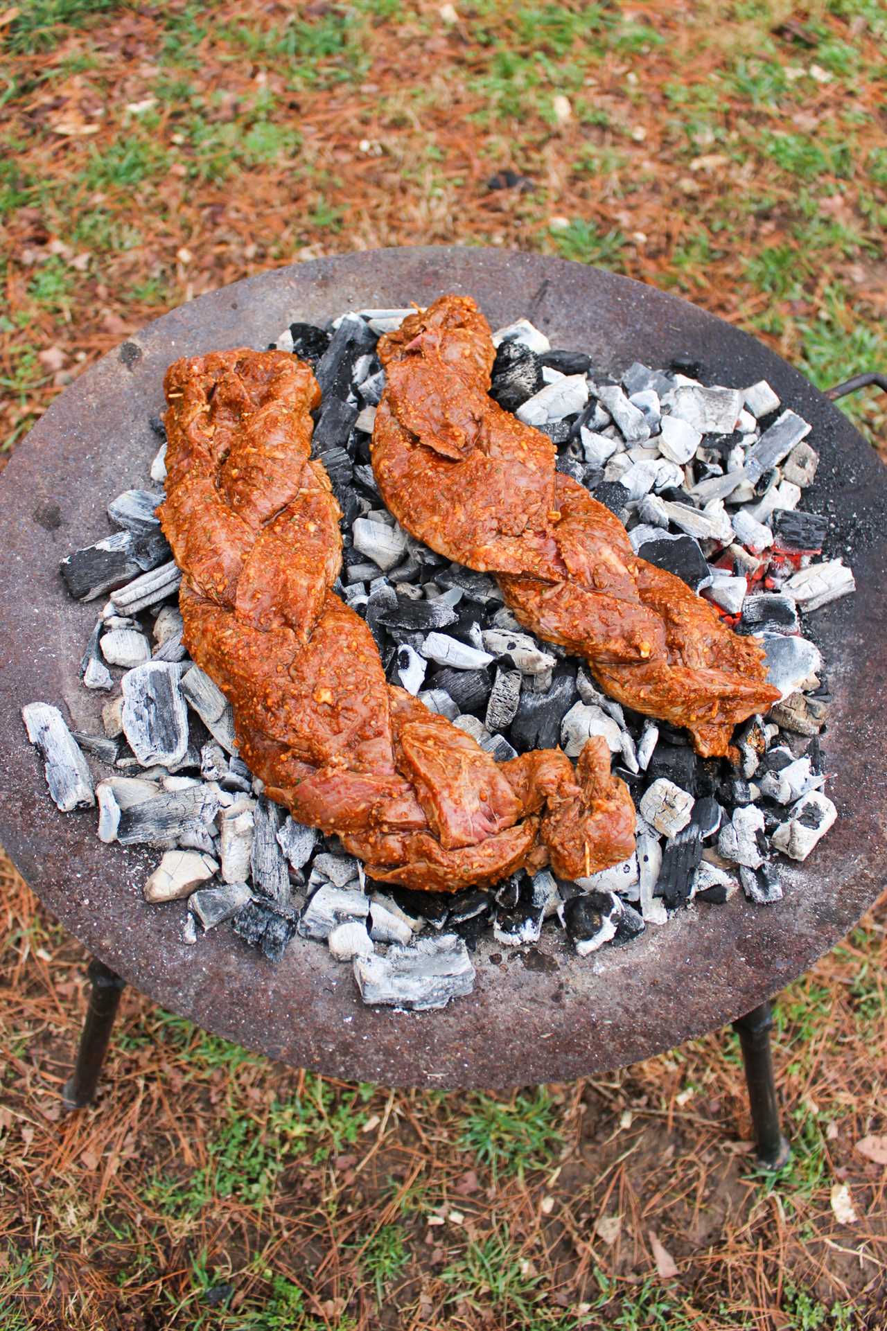 Braided Skirt Steaks getting laid on the coals. 