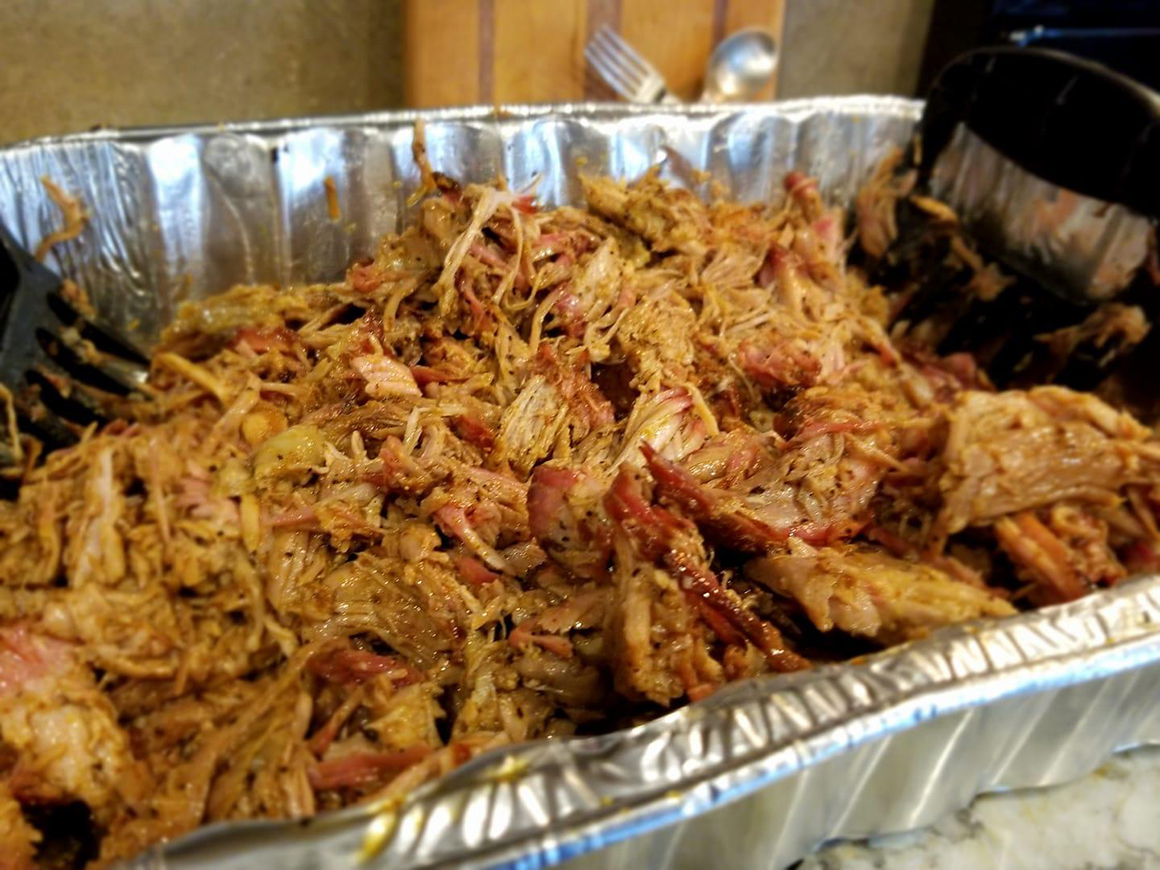 an aluminum tray full of pulled pork