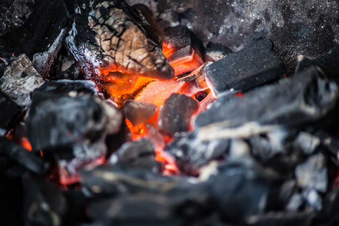 a close up of glowing coal pieces burning