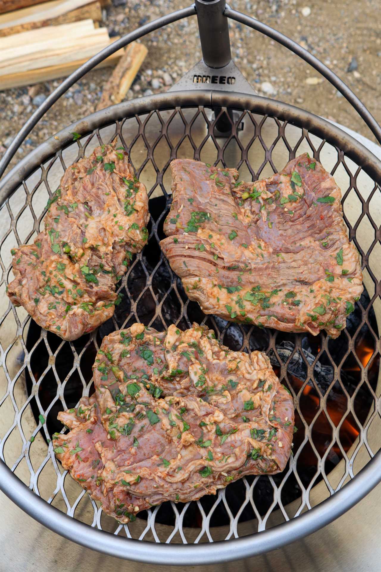 Chipotle Beer Steak has been marinated and is starting to cook over the flames.