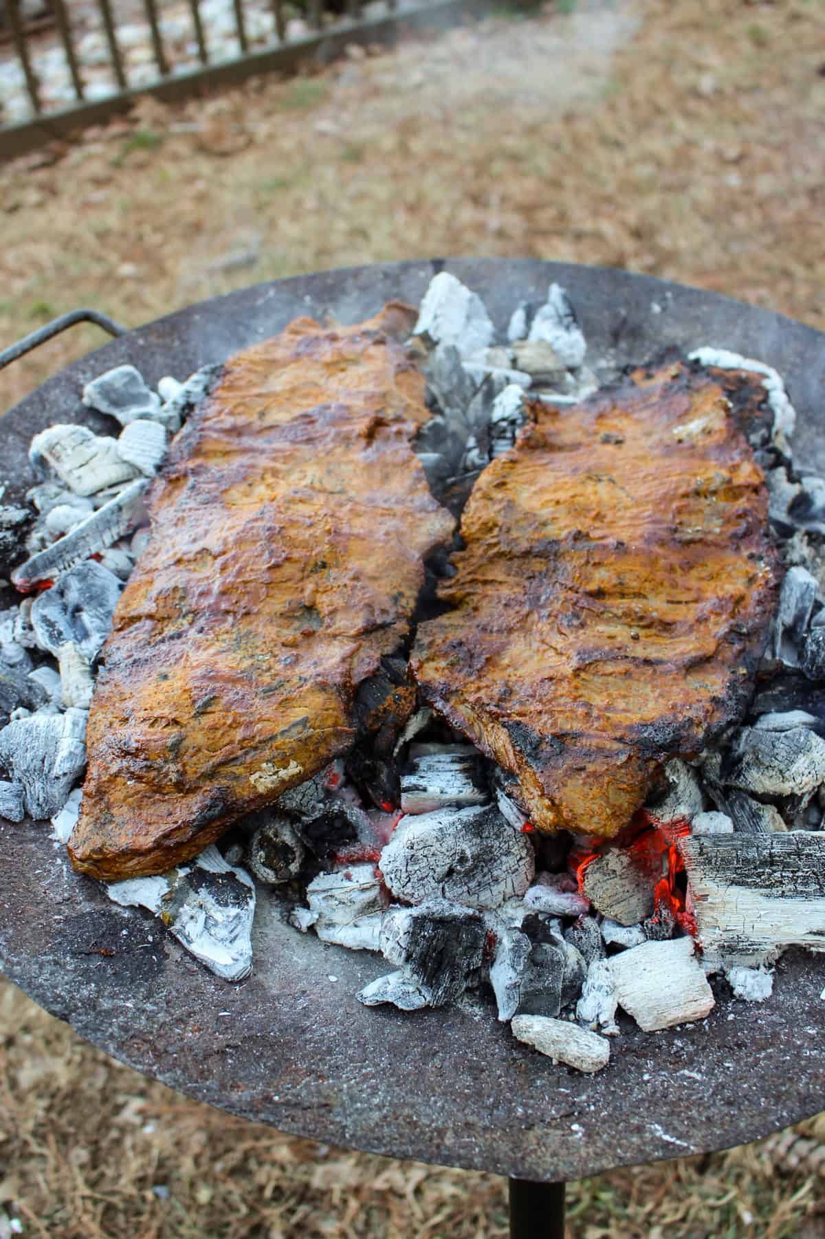 Skirt steaks after they've been flipped on the coals. 