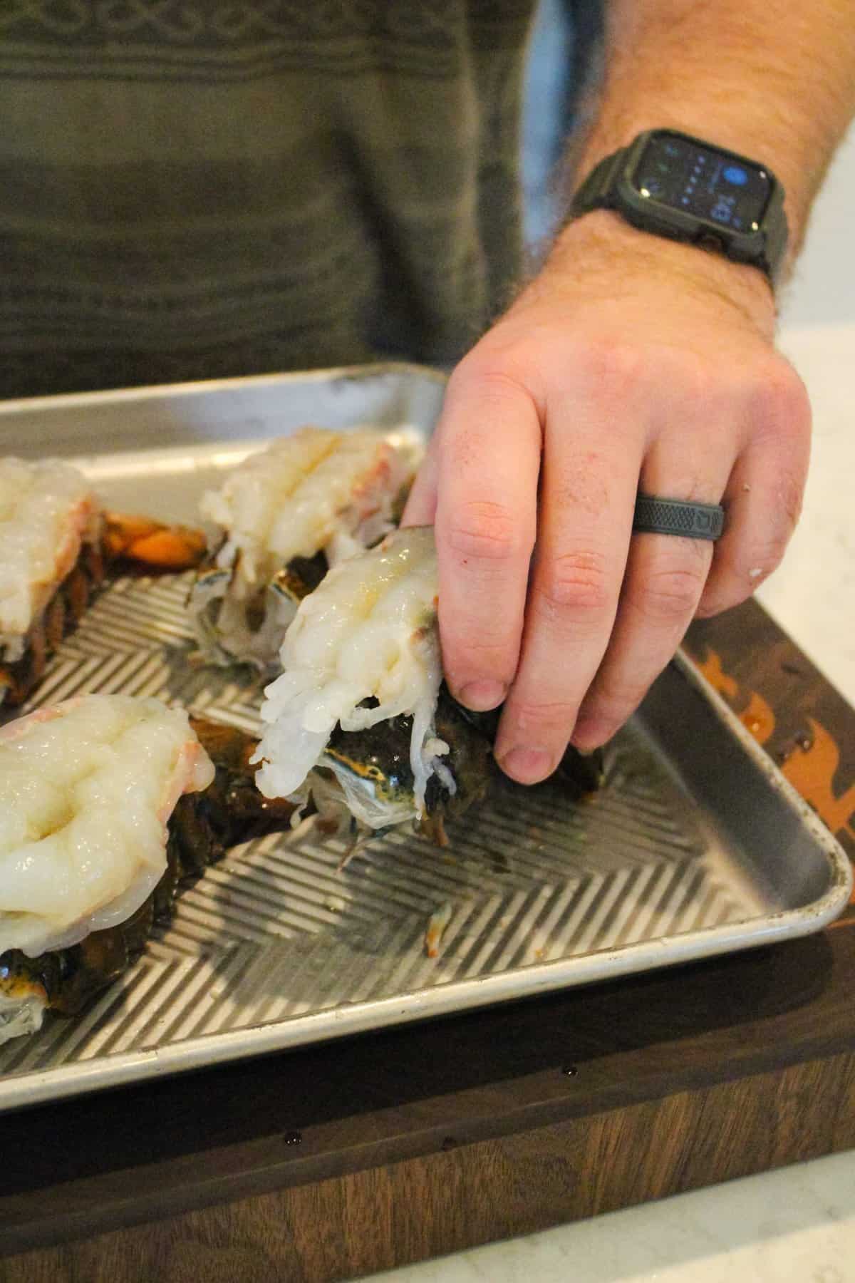 Lobster tails getting butterflied and prepared for seasoning. 