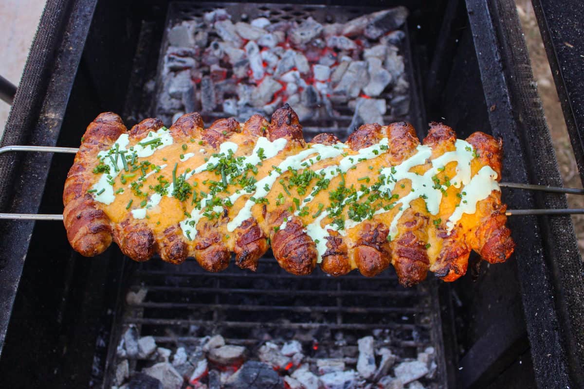 The sausage skewers after a drizzle of ranch and garnished with scallions.