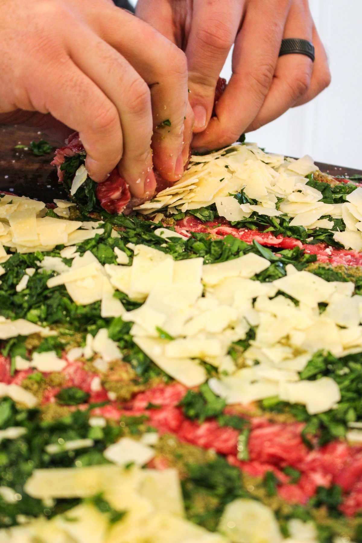 Skirt steaks getting rolled into pinwheels.