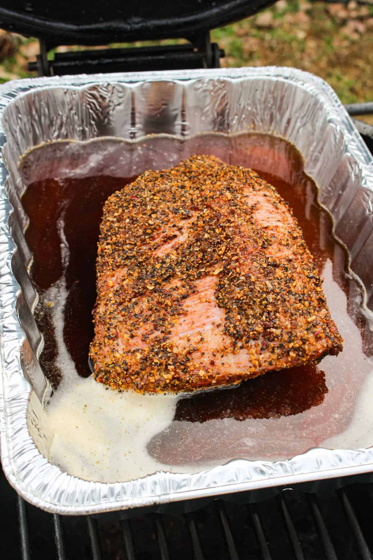 Corned Beef Hash getting placed in a cooking tray with Irish beer. 