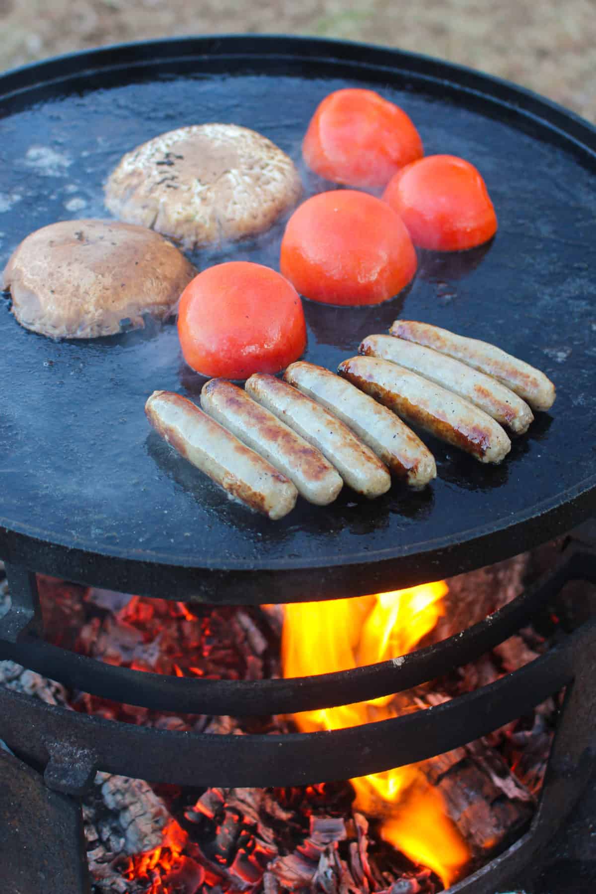 Mushrooms, tomatoes and sausage hitting the plancha.