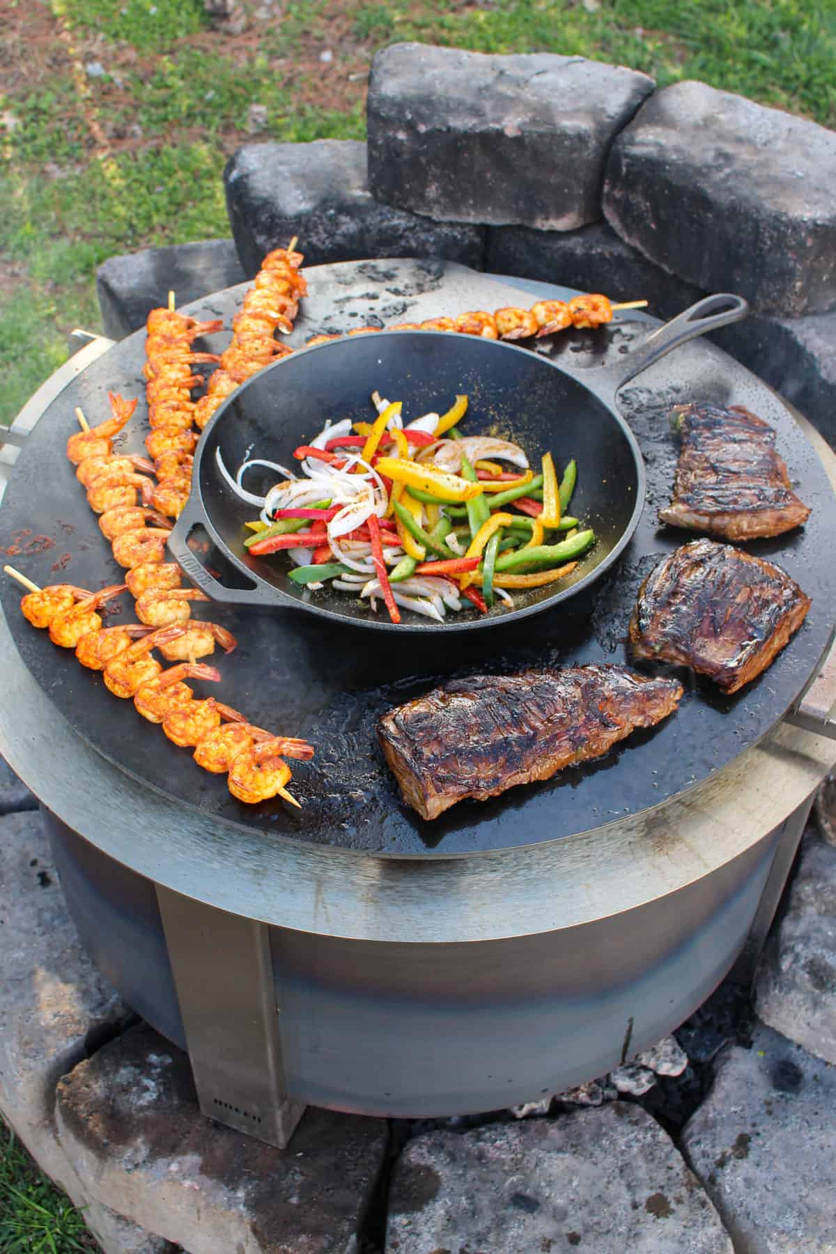 Surf and Turf Fajitas cooking with the veggies added to the grill.