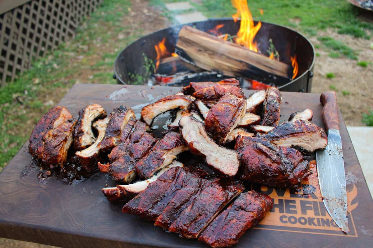 Ribs sitting on a cutting board, sliced and ready to serve.