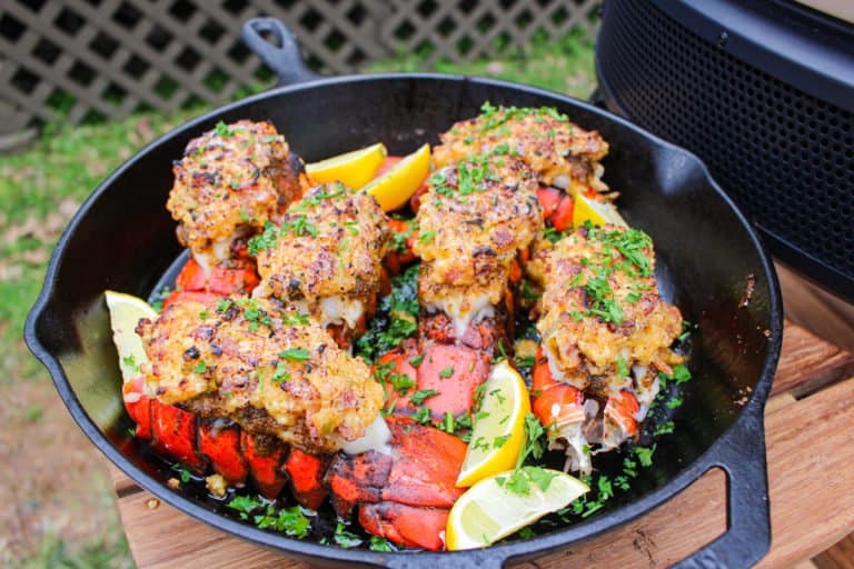 Bacon Stuffed Lobster Tails garnished with parsley and ready to serve.