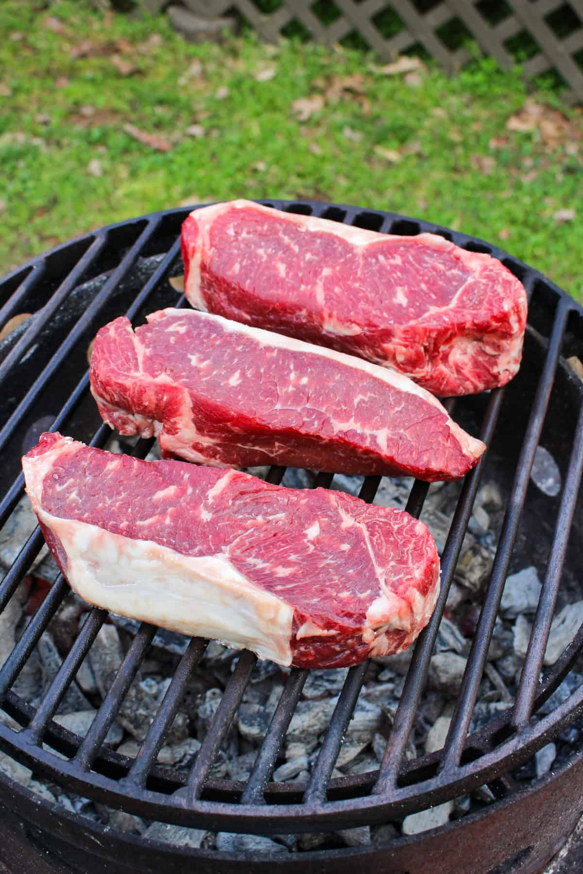 Grilled NY Strip steaks getting started on the grill. 