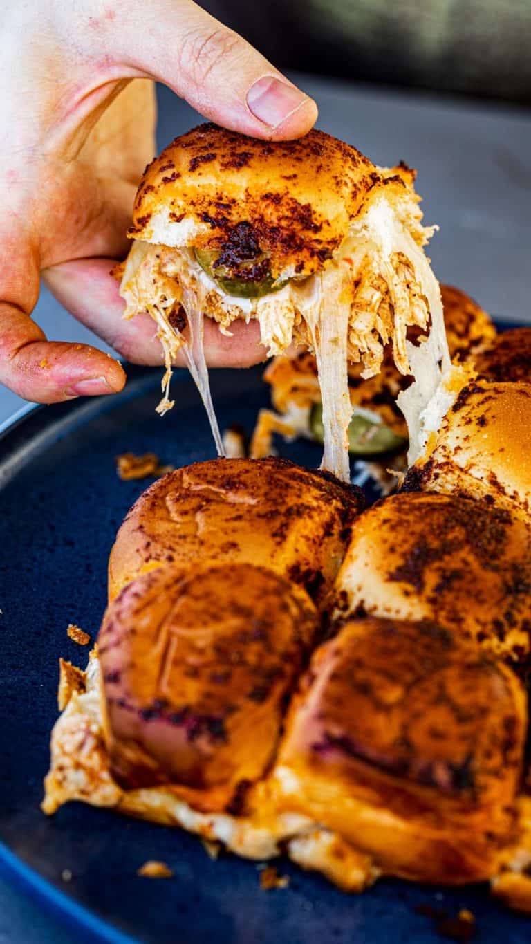 A Nashville Hot Chicken Slider getting pulled from the serving platter.