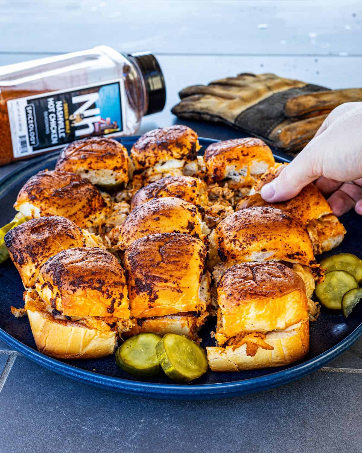 Nashville Hot Chicken Sliders plated with the seasoning in the background.