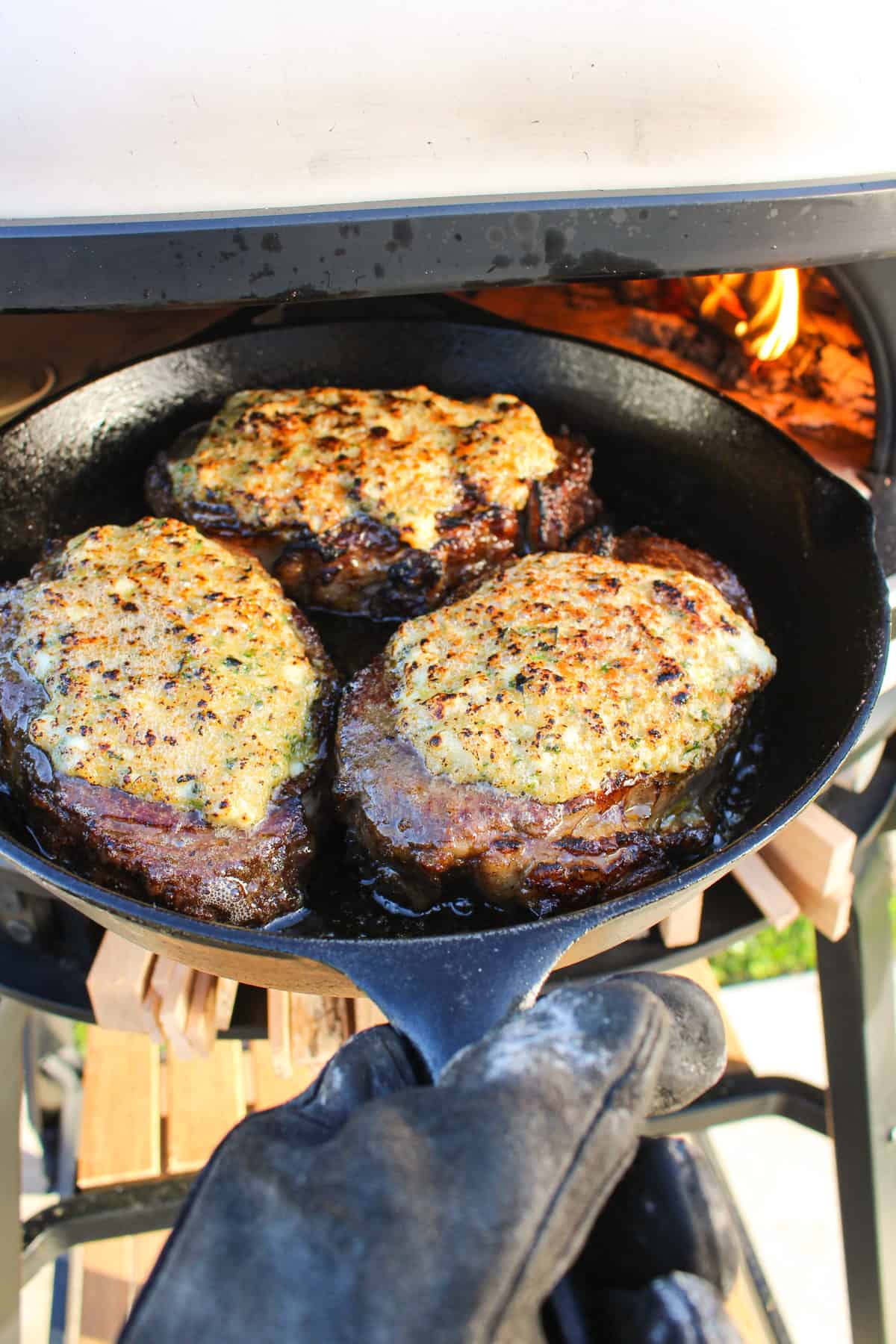 seared blue cheese crusted steaks in a cast iron skillet