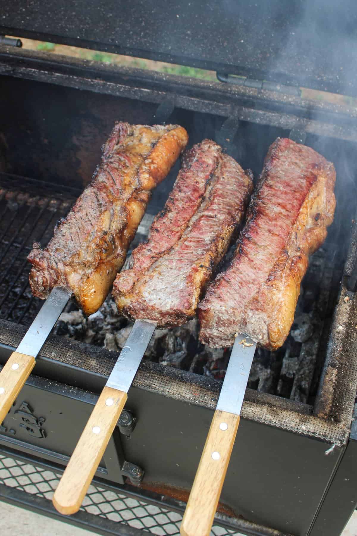 three strip steak skewers on the grill