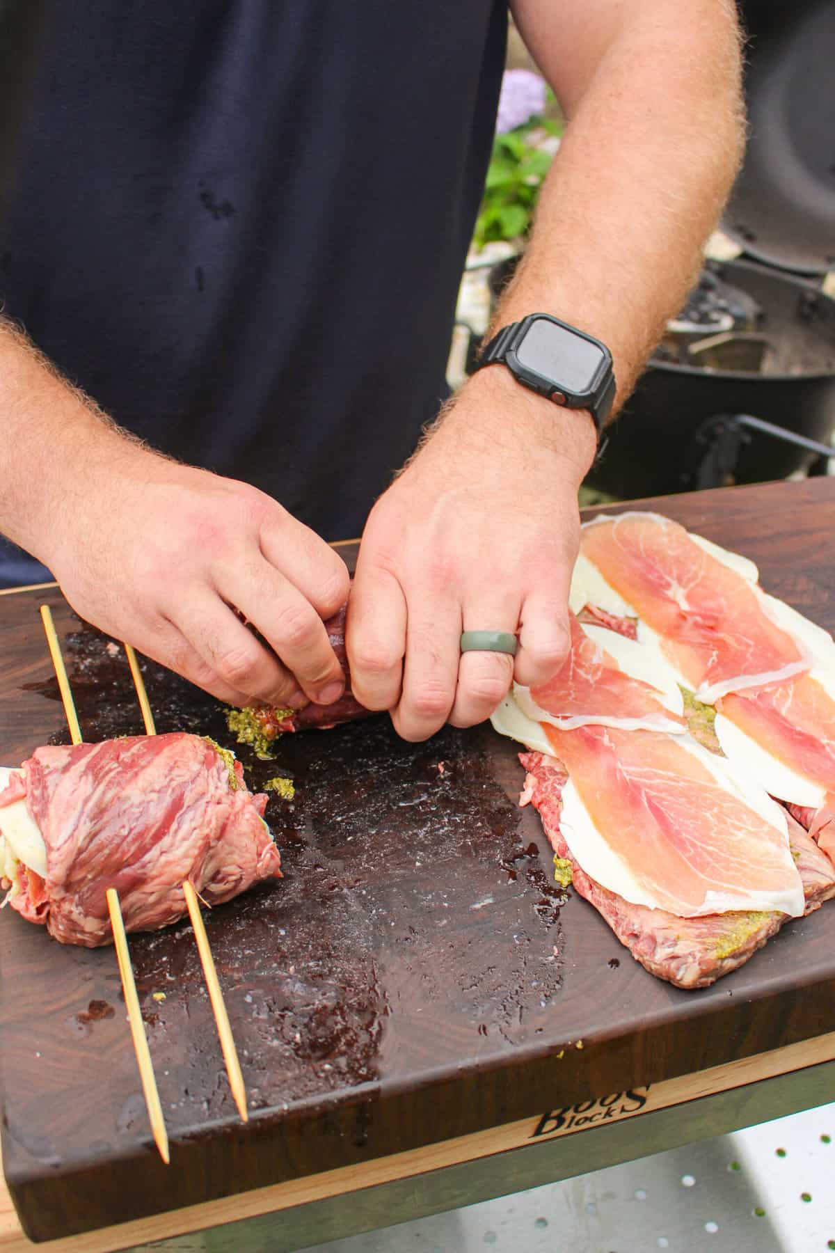 skirt steak being rolled up into pinwheels