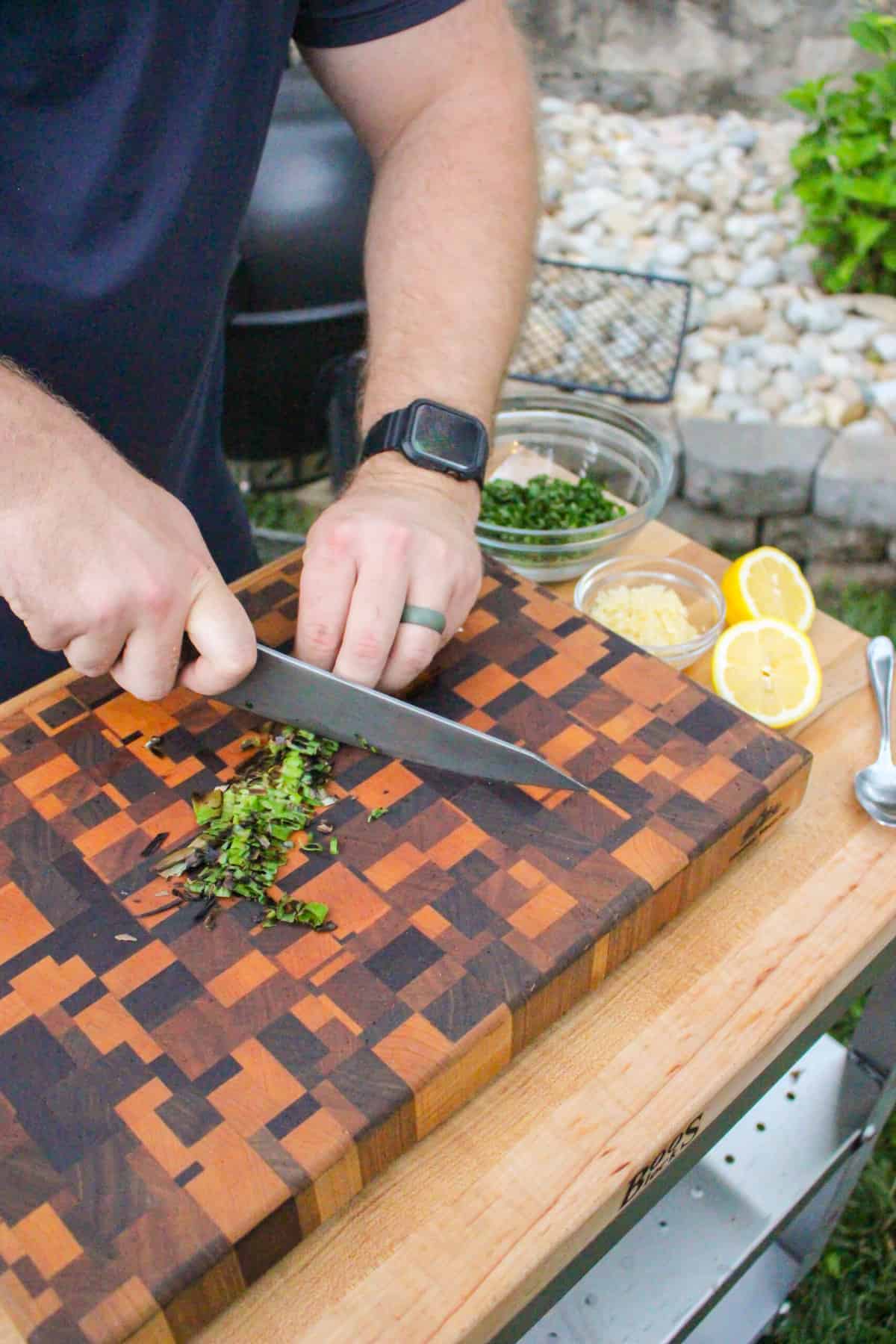 charred scallions being chopped