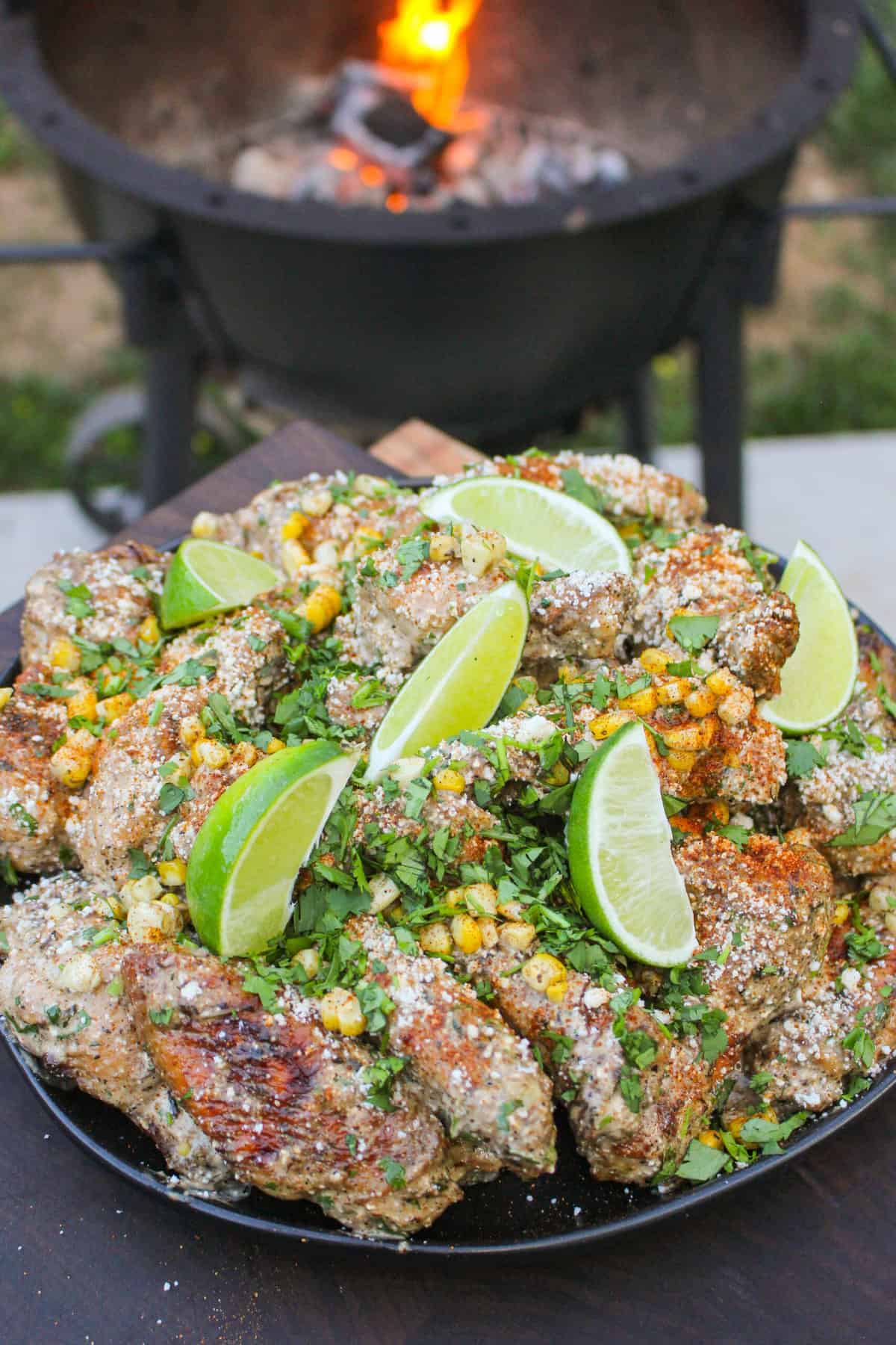 overhead of a plate of wings in front of a grill