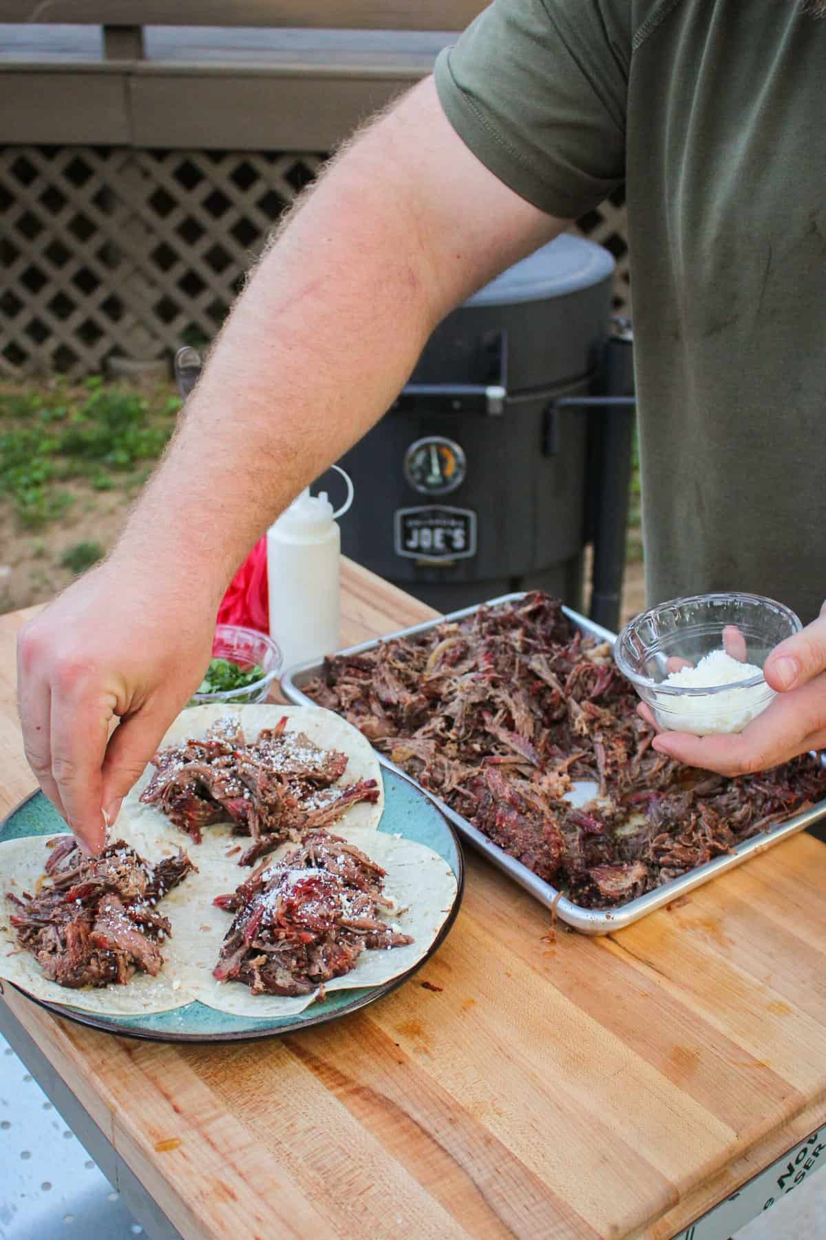 tacos being sprinkled with salt