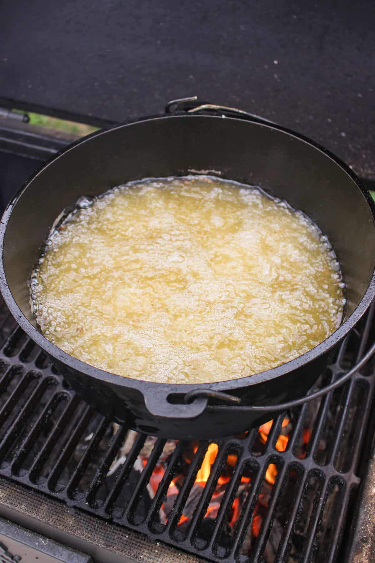 a skillet full of hot oil on a smoker