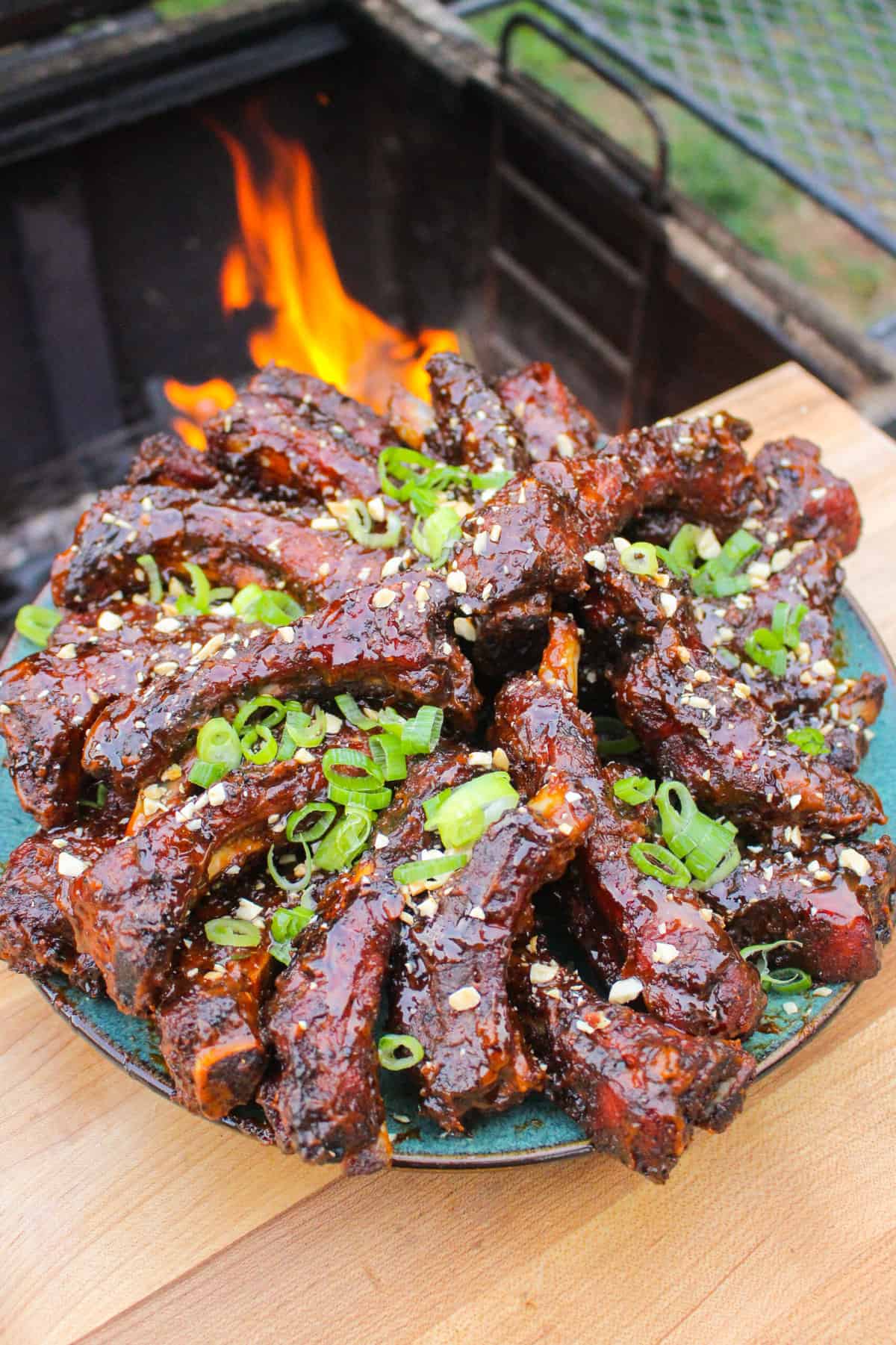 overhead of a plate full of finished peanut butter and jelly sticky ribs with garnishes