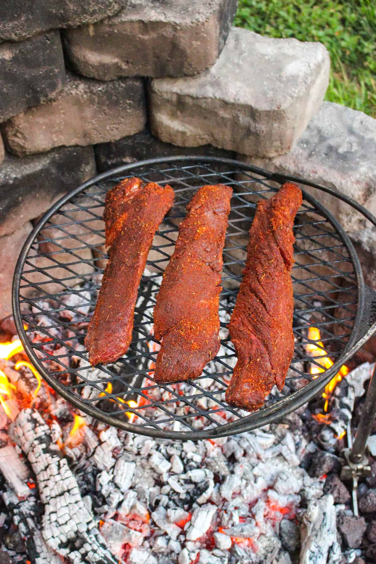 three steaks on a grill overhead