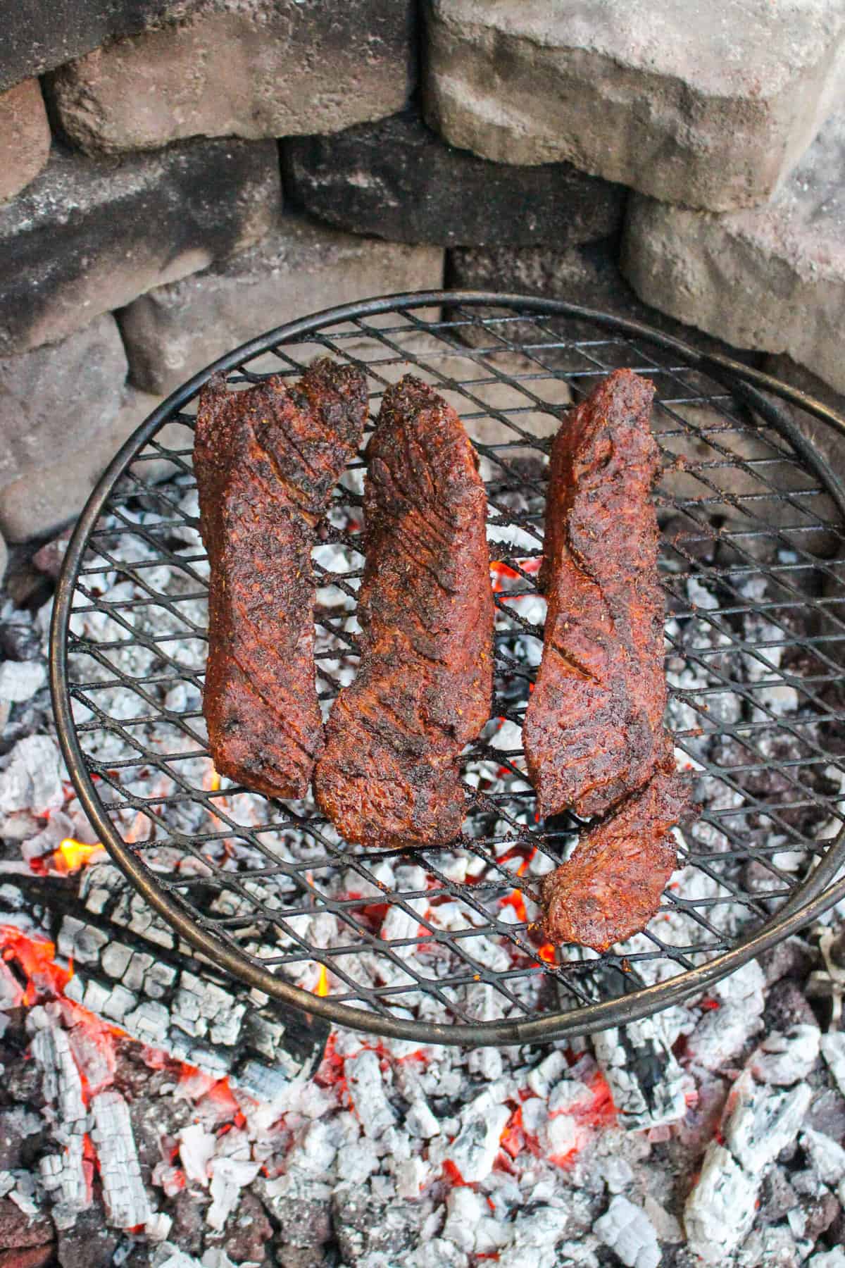 cooked steak for steak and blue cheese kettle chips on a grill grate