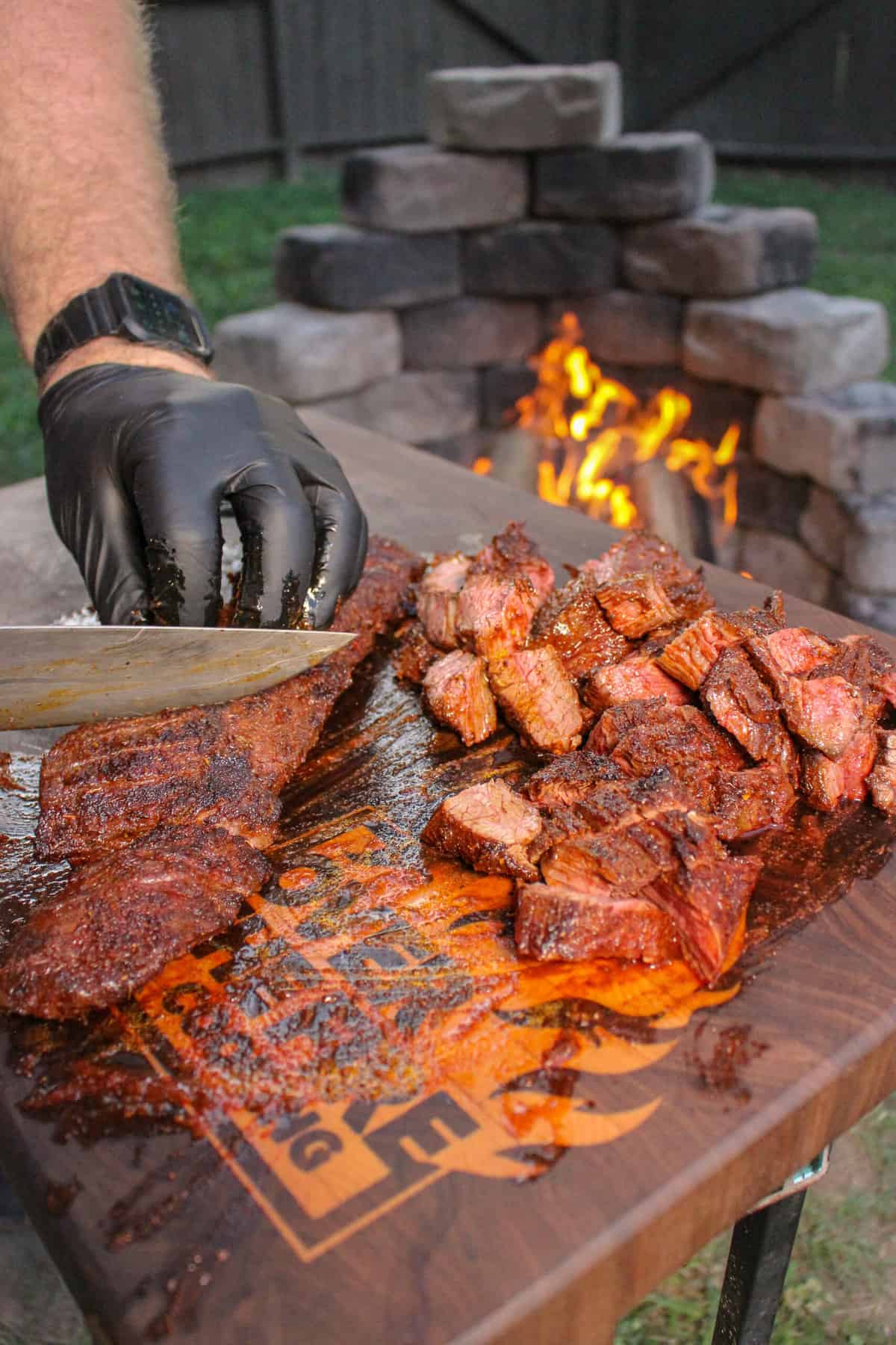 cooked steak being cut into bite-sized pieces