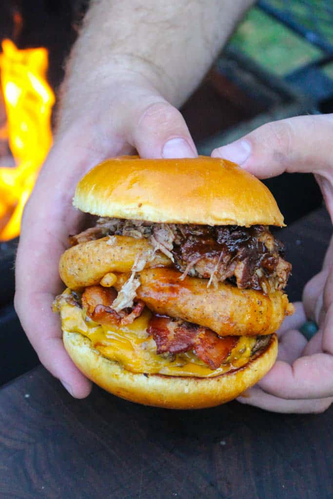 a western bbq burger held over a fire