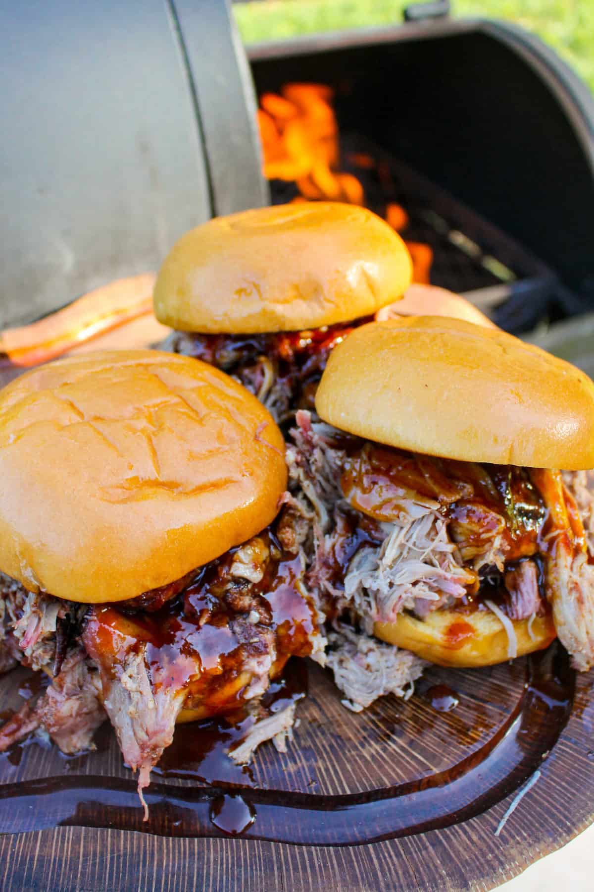 three chipotle bbq pulled pork sandwiches on a cutting board