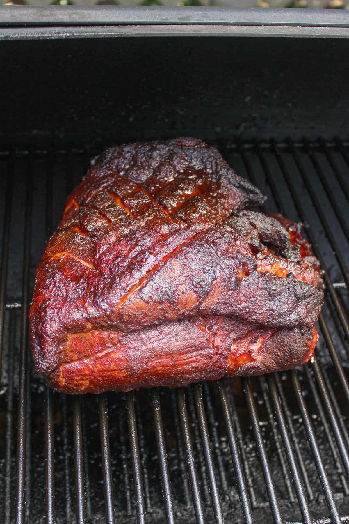 a whole pork butt in a smoker