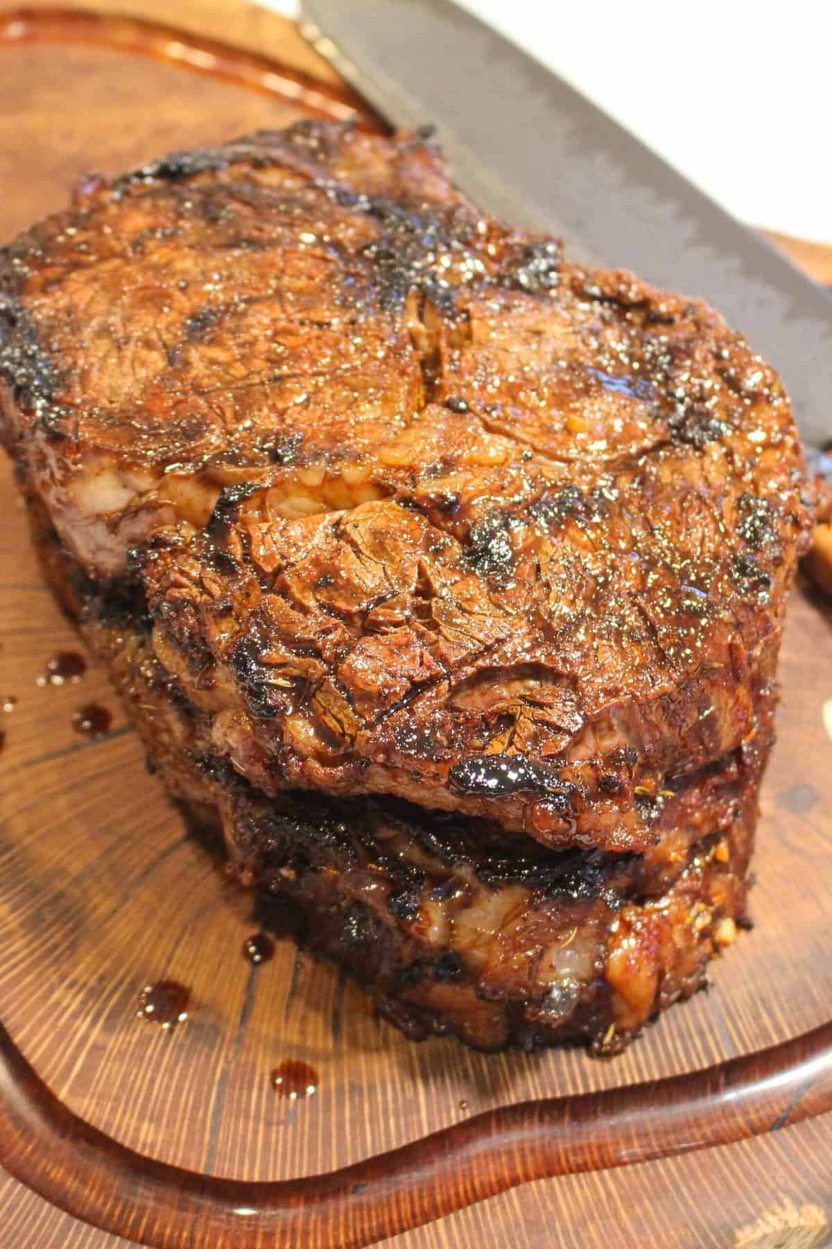 overhead of a cooked ribeye steak on a cutting board