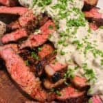 overhead of a pile of bourbon marinated ribeyes smothered in mushroom cream sauce