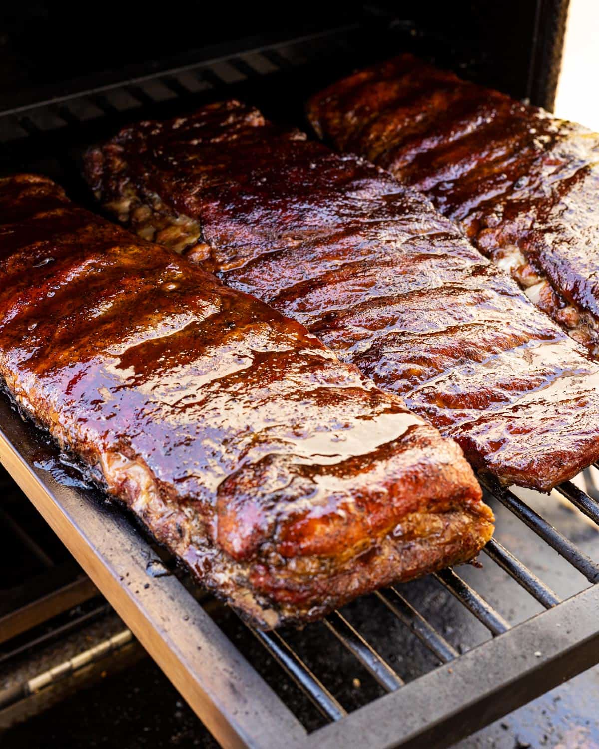 The glazed ribs sitting on the smoker.