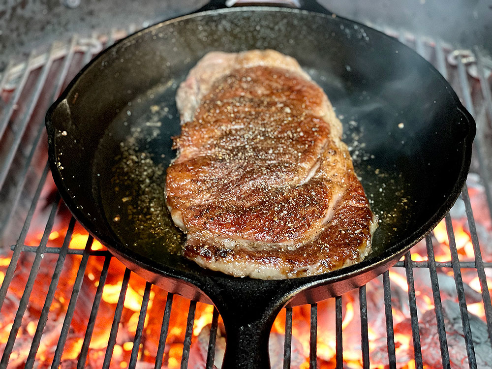 strip steak in the cast iron pan