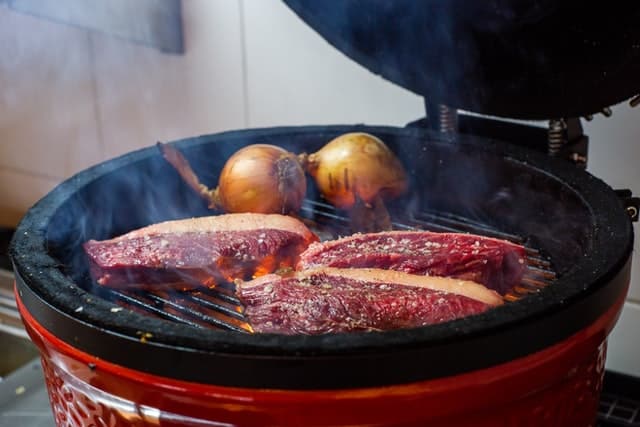 grilling an onion and a meat